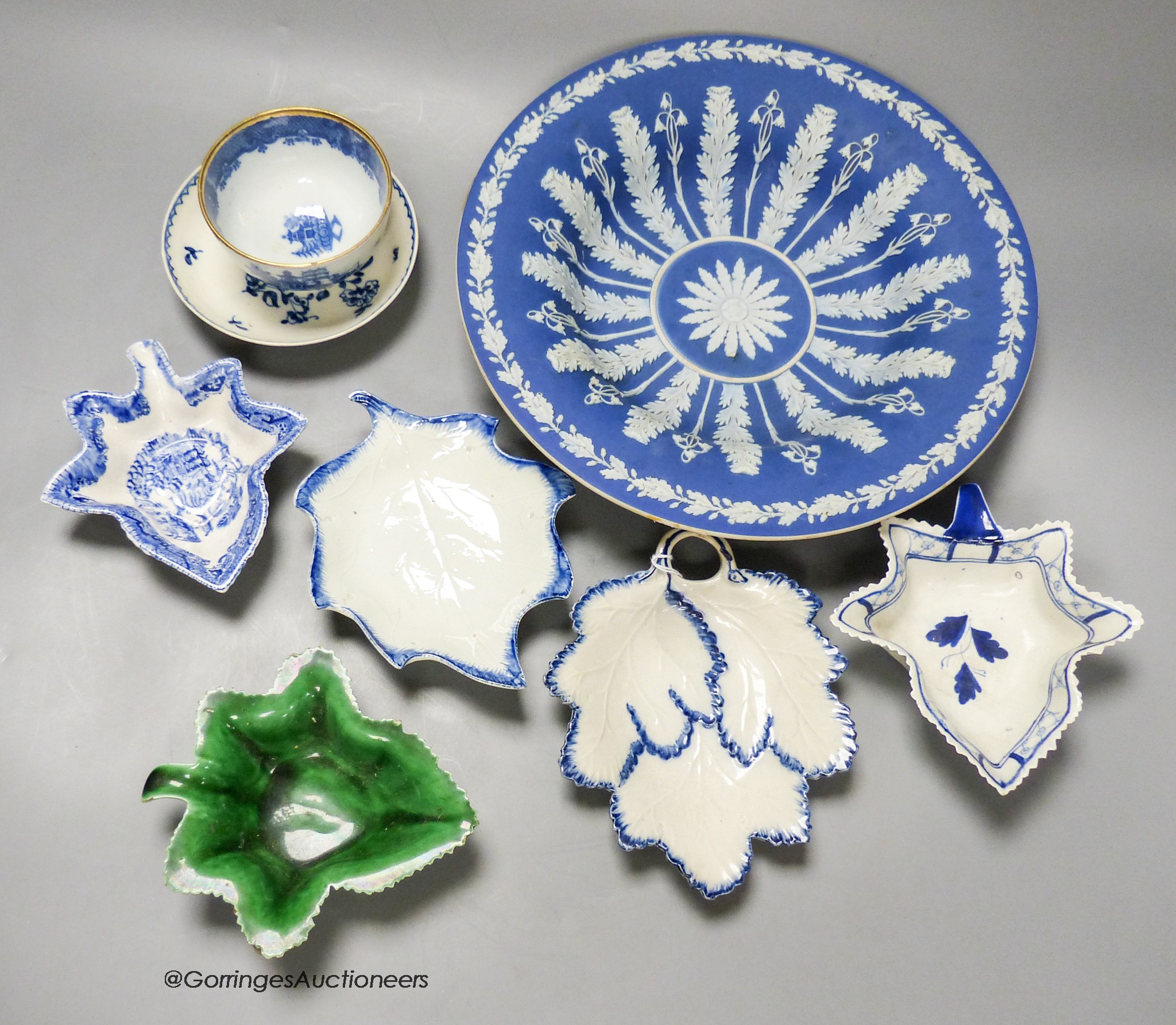 A 19th century Wedgwood blue jasper dish in classical style, five leaf dishes, a blue painted creamware saucer and a blue printed teabowl